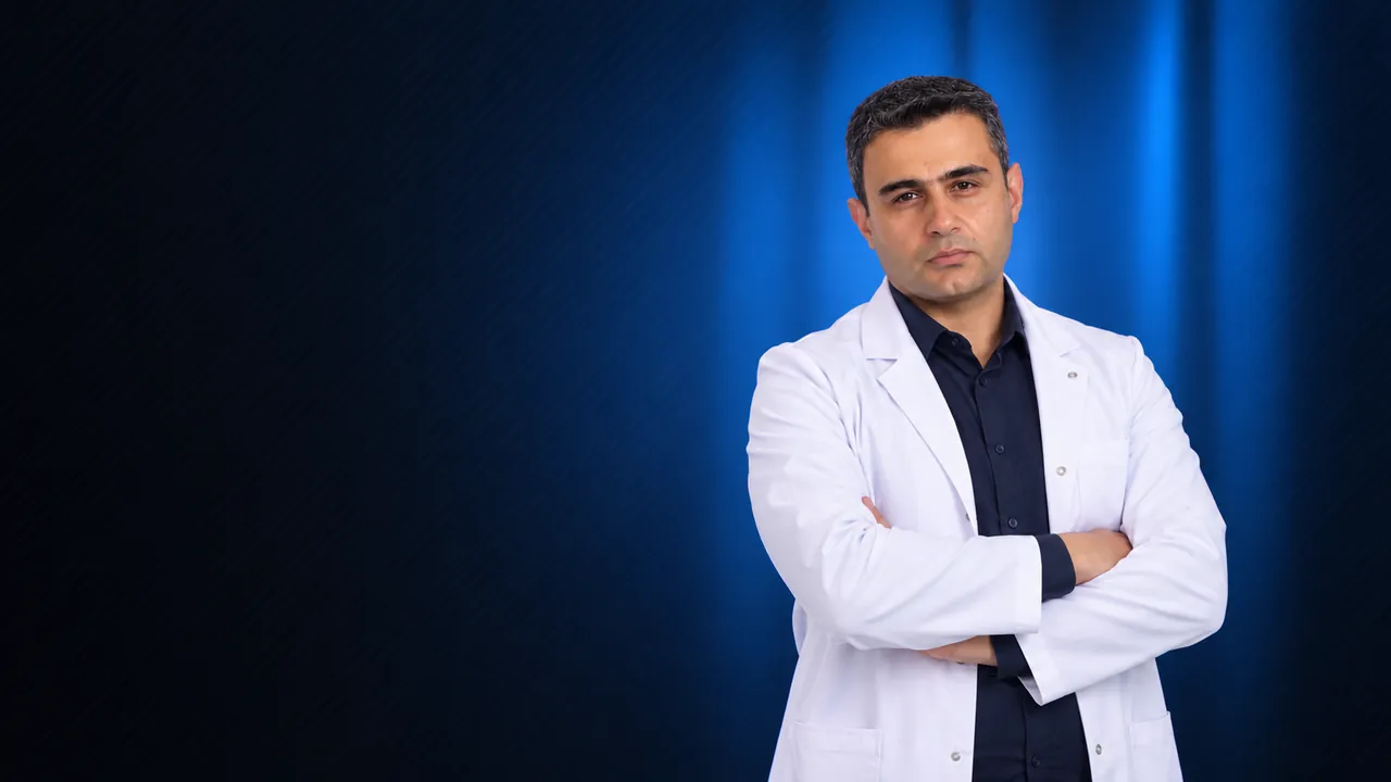 Dr. Hayk Gasparyan in a white coat, arms crossed, blue backdrop