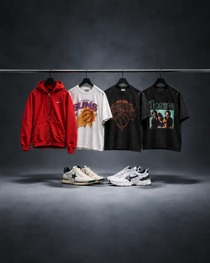 Utopia clothing — hoodie and graphic tees on a rail with sneakers below